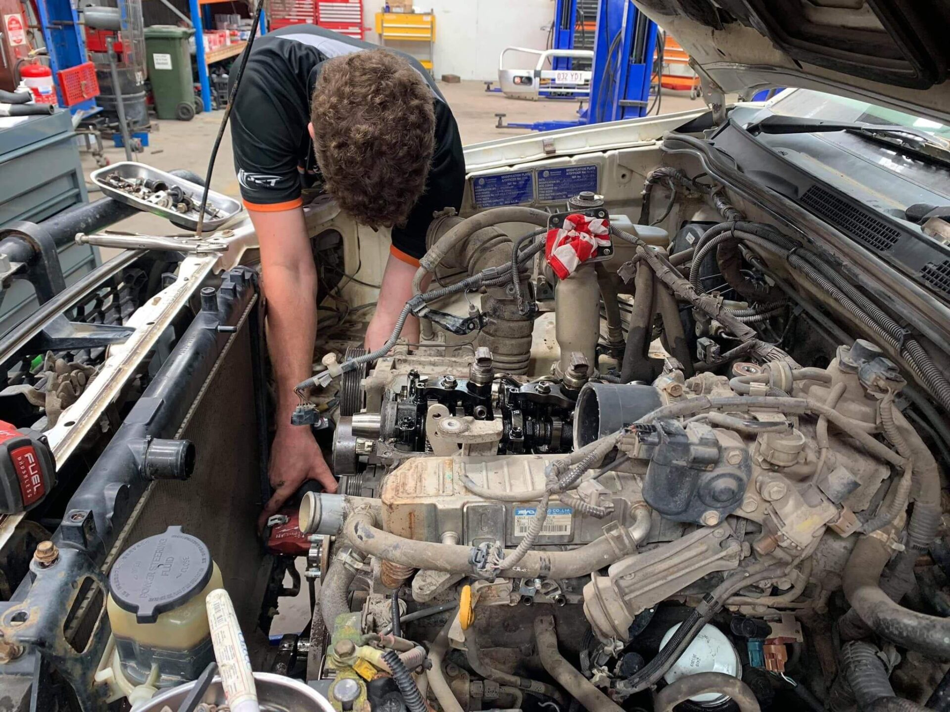 Mechanic fixing car engine - Jet Mining Services